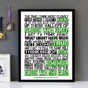 Framed wall art with black, white and green text of the song lyrics from Green And Grey by the band New Model Army.