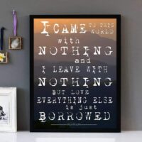Framed wall art with white text of the song lyrics of Everything Is Borrowed by The Streets. A mountainscape is featured in the background.