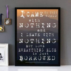 Framed wall art with white text of the song lyrics of Everything Is Borrowed by The Streets. A mountainscape is featured in the background.